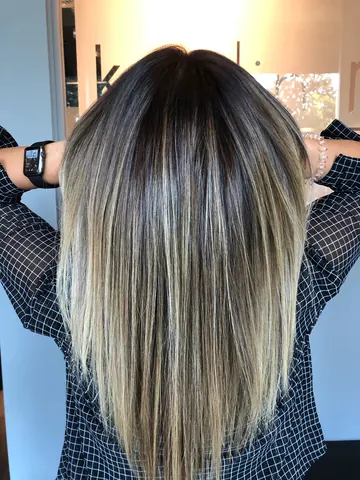 Lived-in blonde balayage on long straight hair, back view